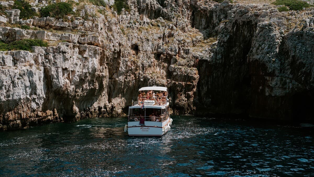 Kanela Tours wooden boat sailing near Kornati cliffs